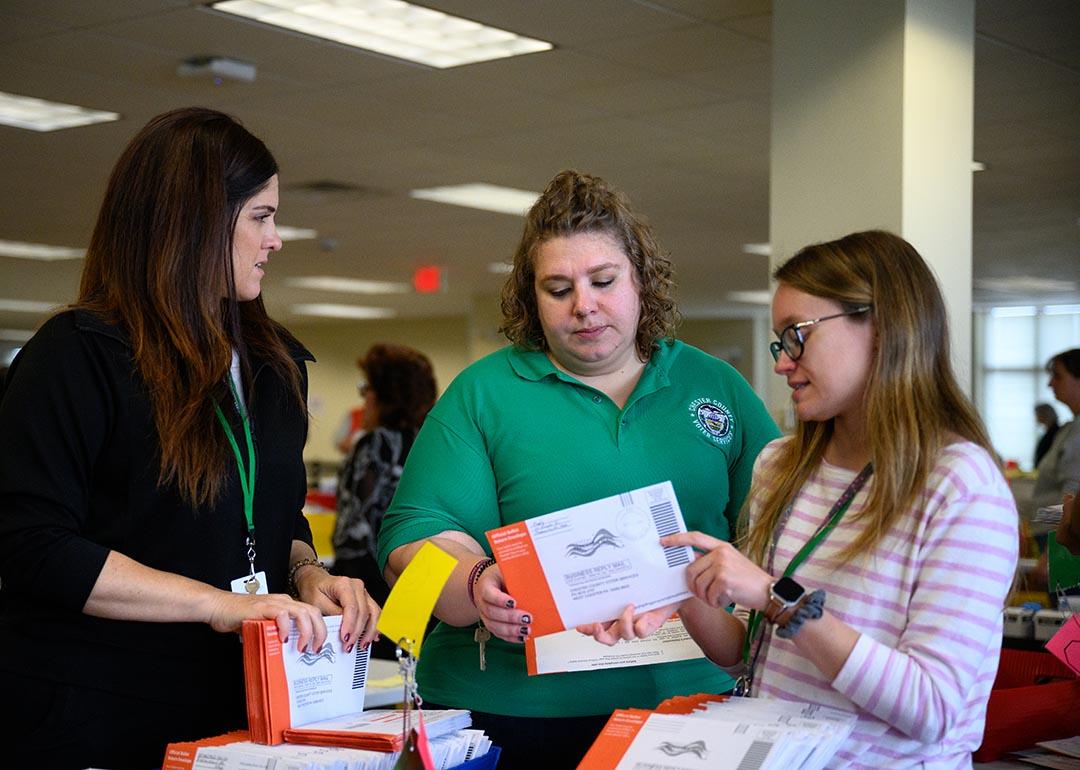 Election workers review a mail-in ballot with an incorrect signature at Chester County's central scanning location in West Chester, Pennsylvania.