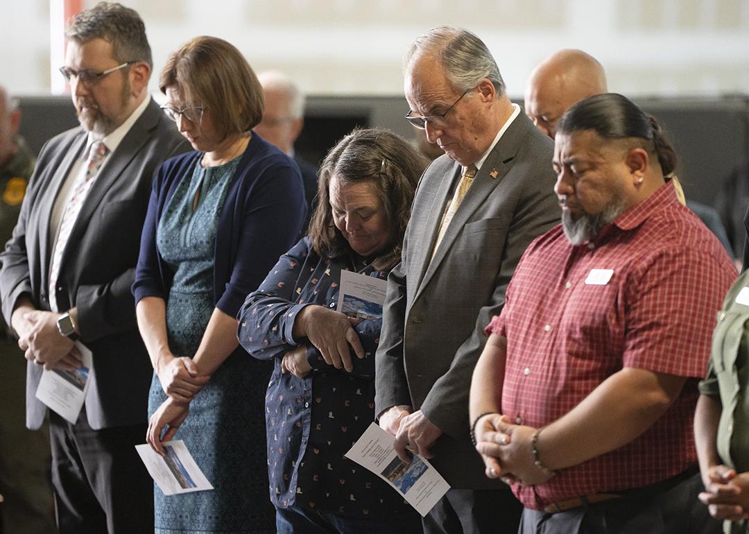 Cochise County Supervisor Peggy Judd, center, bows her head in prayer during the inauguration of the Southern Arizona Regional Border Operations Center in Sierra Vista, Arizona.